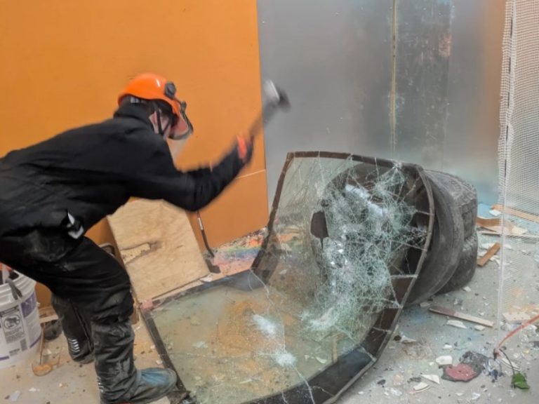 smashing windshield at Wreck N Roll smash room Des Moines